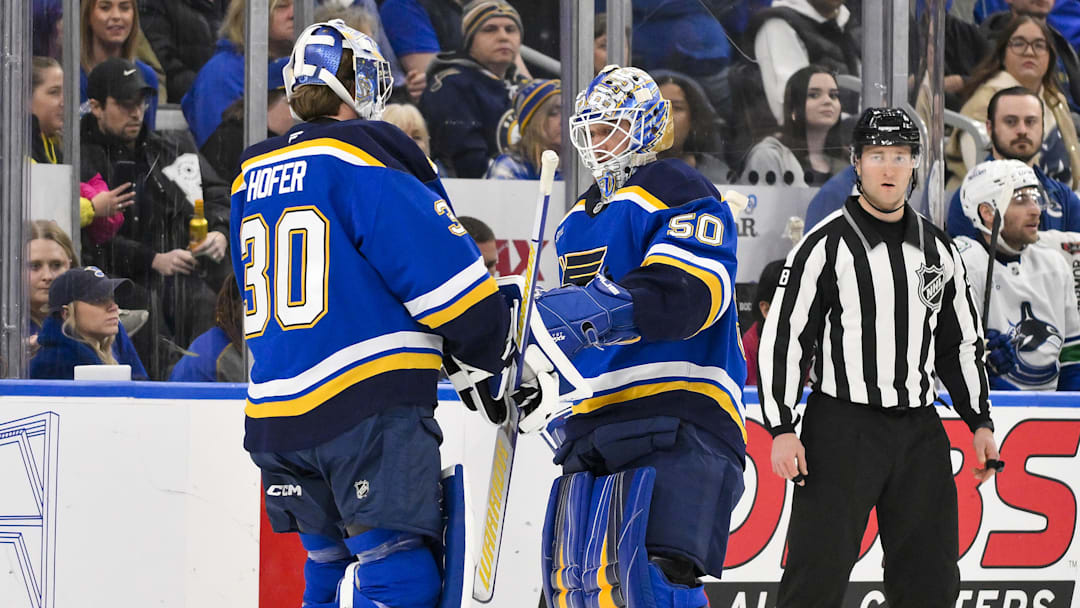 Jan 27, 2025; St. Louis, Missouri, USA;  St. Louis Blues goaltender Jordan Binnington (50) is replaced by goaltender Joel Hofer (30) during the second period against the Vancouver Canucks at Enterprise Center. Mandatory Credit: Jeff Curry-Imagn Images