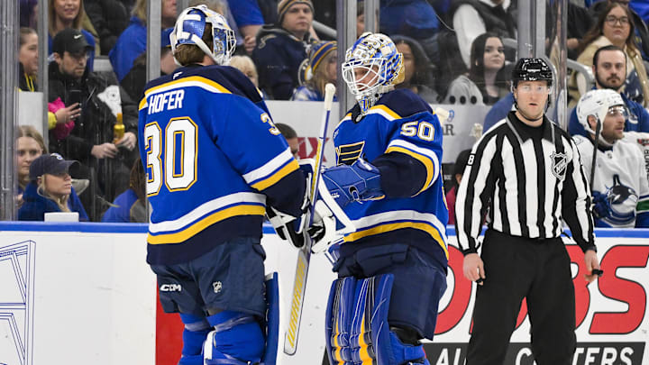 Jan 27, 2025; St. Louis, Missouri, USA;  St. Louis Blues goaltender Jordan Binnington (50) is replaced by goaltender Joel Hofer (30) during the second period against the Vancouver Canucks at Enterprise Center. Mandatory Credit: Jeff Curry-Imagn Images