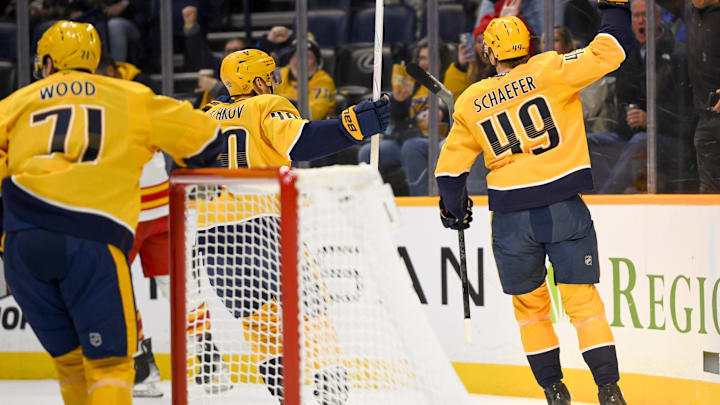 Dec 2, 2025; Nashville, Tennessee, USA;  Nashville Predators left wing Reid Schaefer (49) celebrates his goal against the Calgary Flames during the first period at Bridgestone Arena. Mandatory Credit: Steve Roberts-Imagn Images