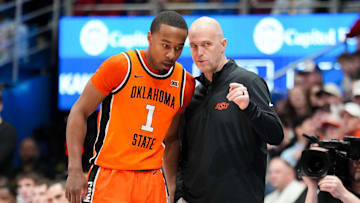 Feb 22, 2025; Lawrence, Kansas, USA; Oklahoma State Cowboys guard Bryce Thompson (1) talks with head coach Steve Lutz against the Kansas Jayhawks during the first half at Allen Fieldhouse. Mandatory Credit: Denny Medley-Imagn Images