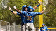 UCLA’s Dean West, left, celebrates his first inning home run with teammate Roman Martin at PK Park in Eugene.
