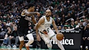 Mar 5, 2025; Boston, Massachusetts, USA; Boston Celtics guard Derrick White (9) drives on Portland Trail Blazers guard Anfernee Simons (1) during the first quarter at TD Garden. Mandatory Credit: Winslow Townson-Imagn Images