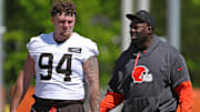 Cleveland Browns defensive tackle Mason Graham  chats with defensive line coach Jacques Cesaire after NFL rookie minicamp.
