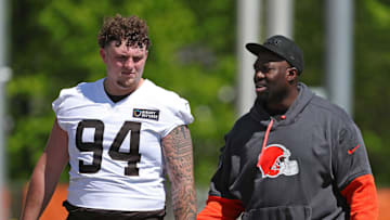 Cleveland Browns defensive tackle Mason Graham (94) chats with defensive line coach Jacques Cesaire after NFL rookie minicamp at the Cleveland Browns training facility on Friday, May 9, 2025, in Berea, Ohio.