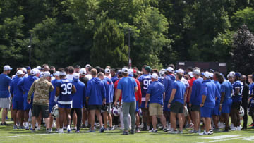 Bills owners Terry Pegula and wife Kim Pegula are surrounded in the team huddle at the end of day three of the Buffalo Bills training camp.