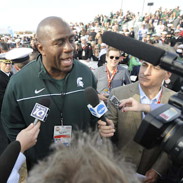 November 10, 2011; San Diego, CA, USA; Michigan State Spartans former player Magic Johnson talks with Navy officials prior to the game game against North Carolina Tar Heels during at the Carrier Classic on board USS Carl Vinson.  Mandatory Credit: Christopher Hanewinckel-Imagn Images