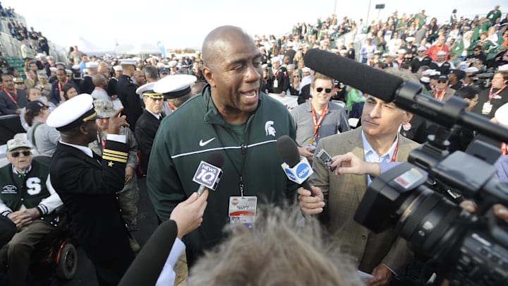 November 10, 2011; San Diego, CA, USA; Michigan State Spartans former player Magic Johnson talks with Navy officials prior to the game game against North Carolina Tar Heels during at the Carrier Classic on board USS Carl Vinson.  Mandatory Credit: Christopher Hanewinckel-Imagn Images