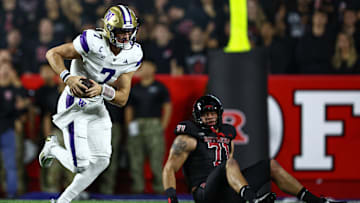 Sep 27, 2024; Piscataway, New Jersey, USA; Washington Huskies quarterback Will Rogers (7) scrambles vs. Rutgers Scarlet Knights offensive lineman John Stone (71) during the first half at SHI Stadium. Mandatory Credit: Vincent Carchietta-Imagn Images