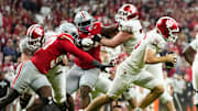 Indiana Hoosiers quarterback Fernando Mendoza (15) scrambles away from Ohio State Buckeyes defensive end Kenyatta Jackson Jr. (97) during the Big Ten Conference championship game at Lucas Oil Stadium in Indianapolis on Dec. 6, 2025. Ohio State lost 13-10.