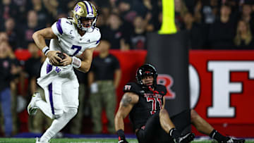 Sep 27, 2024; Piscataway, New Jersey, USA; Washington Huskies quarterback Will Rogers (7) s rambles info Rutgers Scarlet Knights offensive lineman John Stone (71) during the first half at SHI Stadium. Mandatory Credit: Vincent Carchietta-Imagn Images