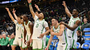 Mar 21, 2025; Seattle, WA, USA; Oregon Ducks guard Jadrian Tracey (2),forward Supreme Cook (7), guard Ra'Heim Moss (0), guard TJ Bamba (5) react from the bench against the Liberty Flames during the second half in the first round of the NCAA Tournament at Climate Pledge Arena. Mandatory Credit: Steven Bisig-Imagn Images