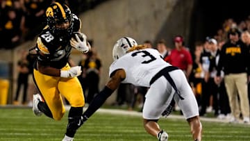 Iowa Hawkeyes running back Kamari Moulton (28) runs with the ball as Penn State Nittany Lions cornerback Antoine Belgrave-Shorter (3) defends during a college football game Oct. 18, 2025 at Kinnick Stadium in Iowa City, Iowa.