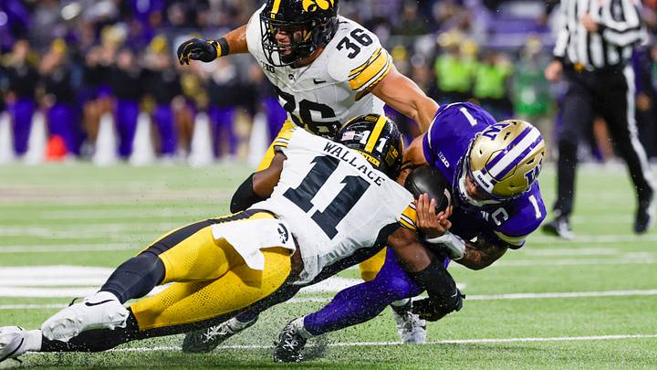 Oct 9, 2026; Seattle, Washington, USA; Iowa Hawkeyes defensive back Jacob Wallace (11) and linebacker Jayden Montgomery (36) tackle Washington Huskies quarterback Demond Williams Jr. (1) during the second quarter at Husky Stadium. Mandatory Credit: Joe Nicholson-Imagn Images