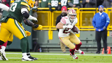 Nov 24, 2024; Green Bay, Wisconsin, USA;  San Francisco 49ers running back Christian McCaffrey (23) rushes with the football during the first quarter against the Green Bay Packers at Lambeau Field. Mandatory Credit: Jeff Hanisch-Imagn Images