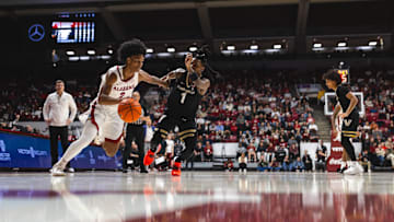 Jan 21, 2025; Tuscaloosa, Alabama, USA; Alabama Crimson Tide guard Aden Holloway (2) drives the ball against Vanderbilt Commodores guard Jason Edwards (1) during the first half at Coleman Coliseum. Mandatory Credit: Will McLelland-Imagn Images