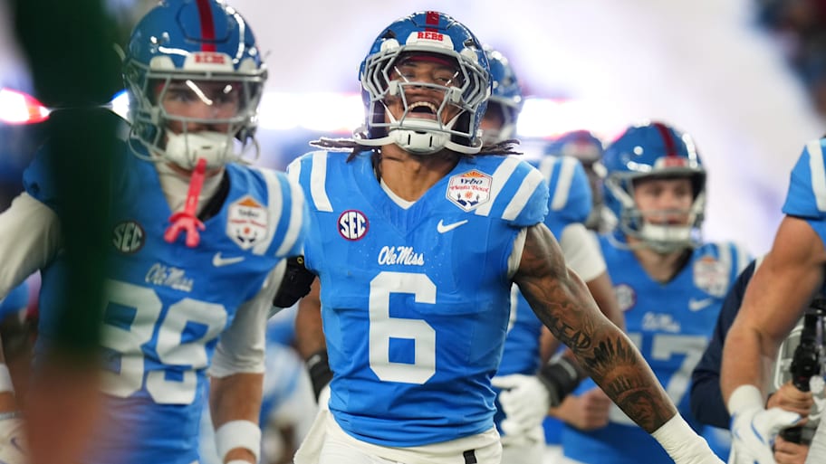 Ole Miss linebacker TJ Dottery takes the field with his teammates.