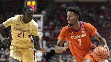 Feb 15, 2025; Tallahassee, Florida, USA; Clemson Tigers forward Chauncey Wiggins (7) drives around Florida State Seminoles forward Alier Maluk (21) during the second half at Donald L. Tucker Center. Mandatory Credit: Melina Myers-Imagn Images
