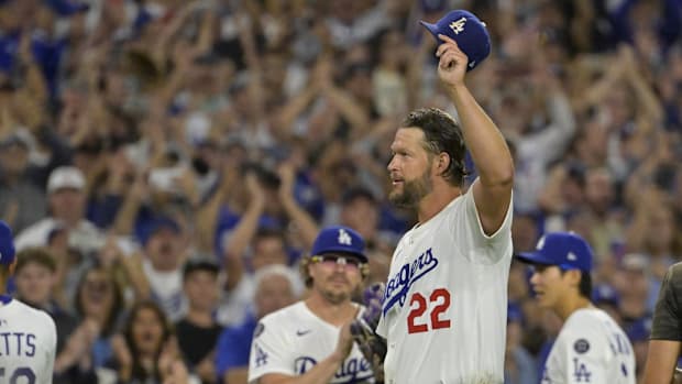 Los Angeles Dodgers starting pitcher Clayton Kershaw (22) tips his cap while walking off the field after throwing the 3000th 