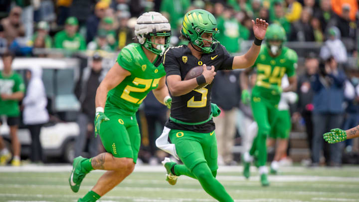Oregon quarterback Dante Moore carries the ball during the Oregon Ducks’ Spring Game Saturday, April 27. 2024 at Autzen Stadium in Eugene, Ore. Oregon quarterback Dante Moore carries the ball during the Oregon Ducks’ Spring Game Saturday, April 27. 2024 at Autzen Stadium in Eugene, Ore.