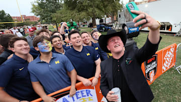 Pat McAfee takes a selfie with Michigan fans on his way to the stage at ESPN College GameDay.