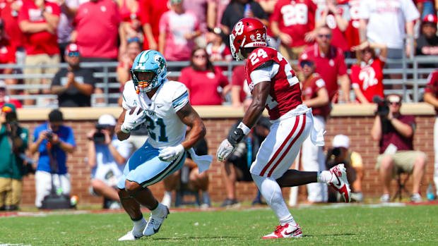 Sep 14, 2024; Norman, Oklahoma, USA;  Tulane Green Wave running back Makhi Hughes (21) runs with the ball as Oklahoma Sooners