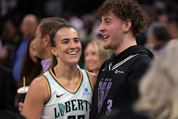 New York Liberty guard Sabrina Ionescu shares a laugh with Golden State Warriors guard Brandin Podziemski. 