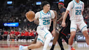 Dec 5, 2025; Toronto, Ontario, CAN; Charlotte Hornets guard KJ Simpson (25) drives to the net against the Toronto Raptors during the second half at Scotiabank Arena. Mandatory Credit: John E. Sokolowski-Imagn Images