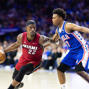 Apr 17, 2024; Philadelphia, Pennsylvania, USA; Miami Heat forward Jimmy Butler (22) dribbles the ball past Philadelphia 76ers guard Kyle Lowry (7) during the second quarter of a play-in game of the 2024 NBA playoffs at Wells Fargo Center. Mandatory Credit: Bill Streicher-USA TODAY Sports