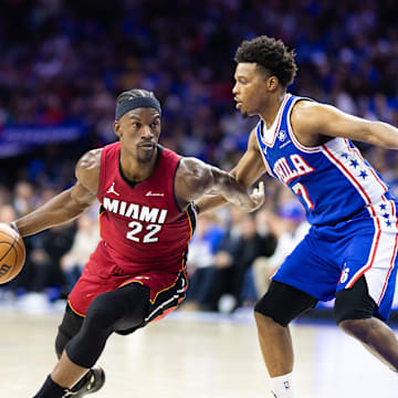 Apr 17, 2024; Philadelphia, Pennsylvania, USA; Miami Heat forward Jimmy Butler (22) dribbles the ball past Philadelphia 76ers guard Kyle Lowry (7) during the second quarter of a play-in game of the 2024 NBA playoffs at Wells Fargo Center. Mandatory Credit: Bill Streicher-Imagn Images