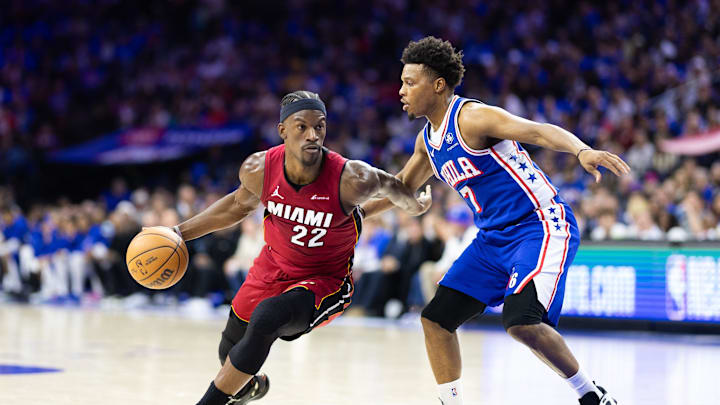 Apr 17, 2024; Philadelphia, Pennsylvania, USA; Miami Heat forward Jimmy Butler (22) dribbles the ball past Philadelphia 76ers guard Kyle Lowry (7) during the second quarter of a play-in game of the 2024 NBA playoffs at Wells Fargo Center. Mandatory Credit: Bill Streicher-Imagn Images