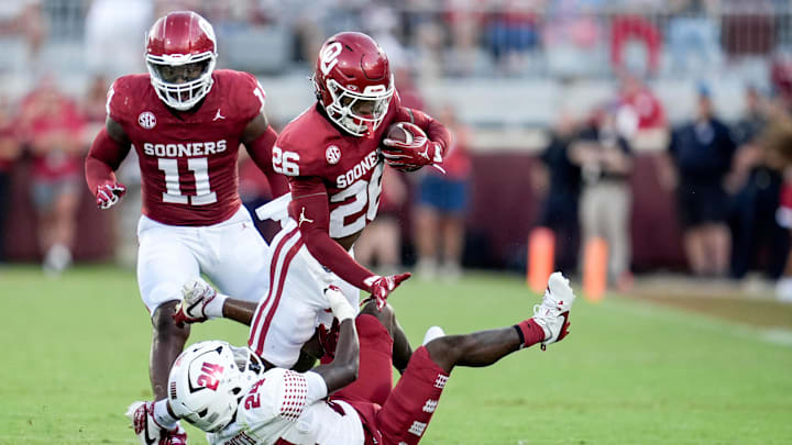 Oklahoma defensive back Kani Walker (26) intercepts the ball and is taken down by Temple running back Joquez Smith (24) 