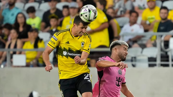 Aug 13, 2024; Columbus, Ohio, USA; Columbus Crew defender Yevhen Cheberko (21) heads the ball over Inter Miami CF defender Marcelo Weigandt (57) during the first half of the Leagues Cup round of 16 game at Lower.com Field. The Crew won 3-2.