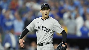 Oct 9, 2024; Kansas City, Missouri, USA; New York Yankees pitcher Luke Weaver (30) celebrates after defeating the Kansas City Royals during game three of the NLDS for the 2024 MLB Playoffs at Kauffman Stadium. Mandatory Credit: Jay Biggerstaff -Imagn Images
