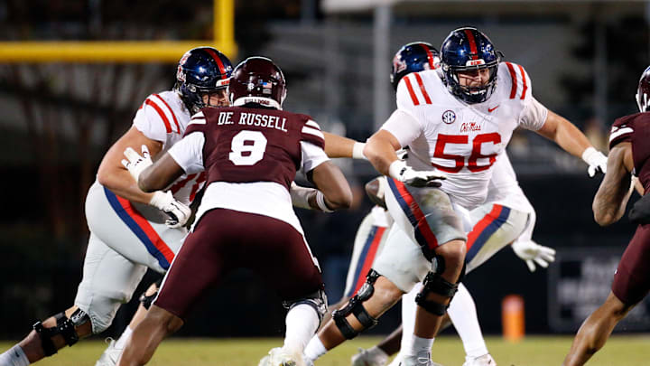 Nov 23, 2023; Starkville, Mississippi, USA; Mississippi Rebels offensive linemen Jeremy James (left) and Mississippi Rebels offensive linemen Reece McIntyre (56) block during the second half  against the Mississippi State Bulldogs at Davis Wade Stadium at Scott Field. Mandatory Credit: Petre Thomas-Imagn Images