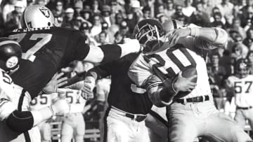 Dec 29, 1974; Oakland, CA, USA; FILE PHOTO; Oakland Raiders defensive end Bubba Smith (77) grabs the facemask of Pittsburgh Steelers running back Rocky Bleier (20) during the 1974 AFC Championship game at the Oakland Coliseum. Mandatory Credit: Malcolm Emmons-USA TODAY Sports