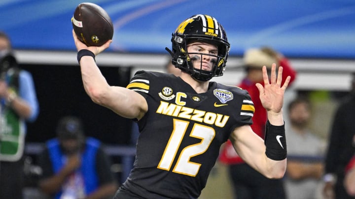 Dec 29, 2023; Arlington, TX, USA; Missouri Tigers quarterback Brady Cook (12) in action during the game between the Ohio State Buckeyes and the Missouri Tigers at AT&T Stadium. Mandatory Credit: Jerome Miron-USA TODAY Sports