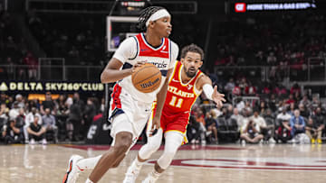 Oct 28, 2024; Atlanta, Georgia, USA; Washington Wizards guard Bilal Coulibaly (0) dribbles past Atlanta Hawks guard Trae Young (11) during the first half at State Farm Arena. Mandatory Credit: Dale Zanine-Imagn Images