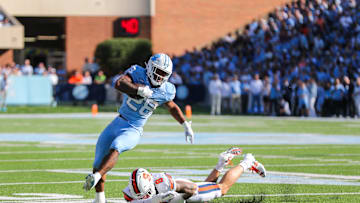 Oct 7, 2023; Chapel Hill, North Carolina, USA; North Carolina Tar Heels running back Omarion Hampton (28) runs the ball while Syracuse Orange defensive back Justin Barron (8) attempts to tackle him during the first half of the game at Kenan Memorial Stadium. Mandatory Credit: Jaylynn Nash-USA TODAY Sports