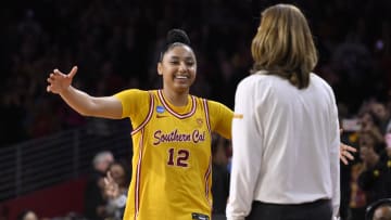 Mar 25, 2024; Los Angeles, CA, USA; USC Trojans guard JuJu Watkins (12) hugs head coach Lindsay Gottlieb during a NCAA Women’s Tournament 2nd round game against the Kansas Jayhawks at Galen Center. Mandatory Credit: Robert Hanashiro-USA TODAY Sports