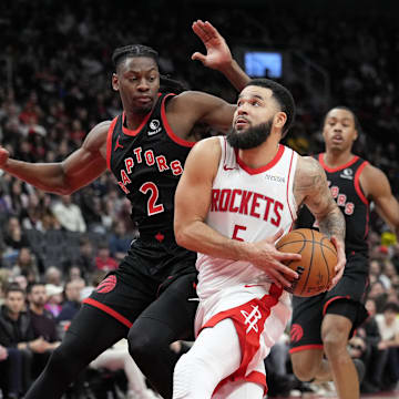 Dec 22, 2024; Toronto, Ontario, CAN; Houston Rockets guard Fred VanVleet (5) drives to the net against Toronto Raptors forward Jonathon Mogbo (2) during the second half at Scotiabank Arena. Mandatory Credit: John E. Sokolowski-Imagn Images