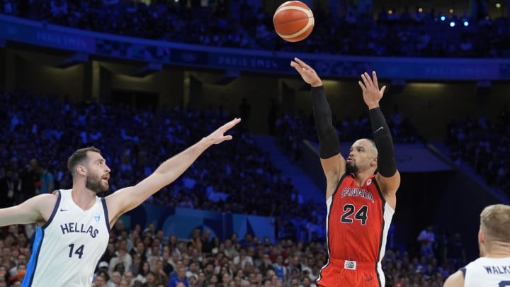 Jul 27, 2024; Villeneuve-d'Ascq, France; Canada small forward Dillon Brooks (24) shoots against Greece centre Georgios Papagiannis (14) in the first quarter during the Paris 2024 Olympic Summer Games at Stade Pierre-Mauroy. Mandatory Credit: John David Mercer-USA TODAY Sports