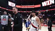 Oct 24, 2025; Portland, Oregon, USA; Portland Trail Blazers interim head coach Tiago Splitter walks towards the locker room with Trail Blazers’ forward Deni Avdija (8) after a 139-119 win over Golden State Warriors in the second half at Moda Center. Mandatory Credit: Jaime Valdez-Imagn Images