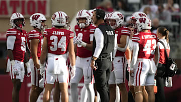 Sep 6, 2025; Madison, Wisconsin, USA;  Wisconsin Badgers head coach Luke Fickell talks with his team during a timeout against the Middle Tennessee Blue Raiders during the second half at Camp Randall Stadium. Mandatory Credit: Kayla Wolf-Imagn Images