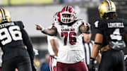 Nov 9, 2024; Nashville, Tennessee, USA;  South Carolina Gamecocks offensive lineman Torricelli Simpkins III (76) points to Vanderbilt Commodores linebacker Bryan Longwell (4) and defensive lineman Khordae Sydnor (96) during the second half at FirstBank Stadium. Mandatory Credit: Steve Roberts-Imagn Images