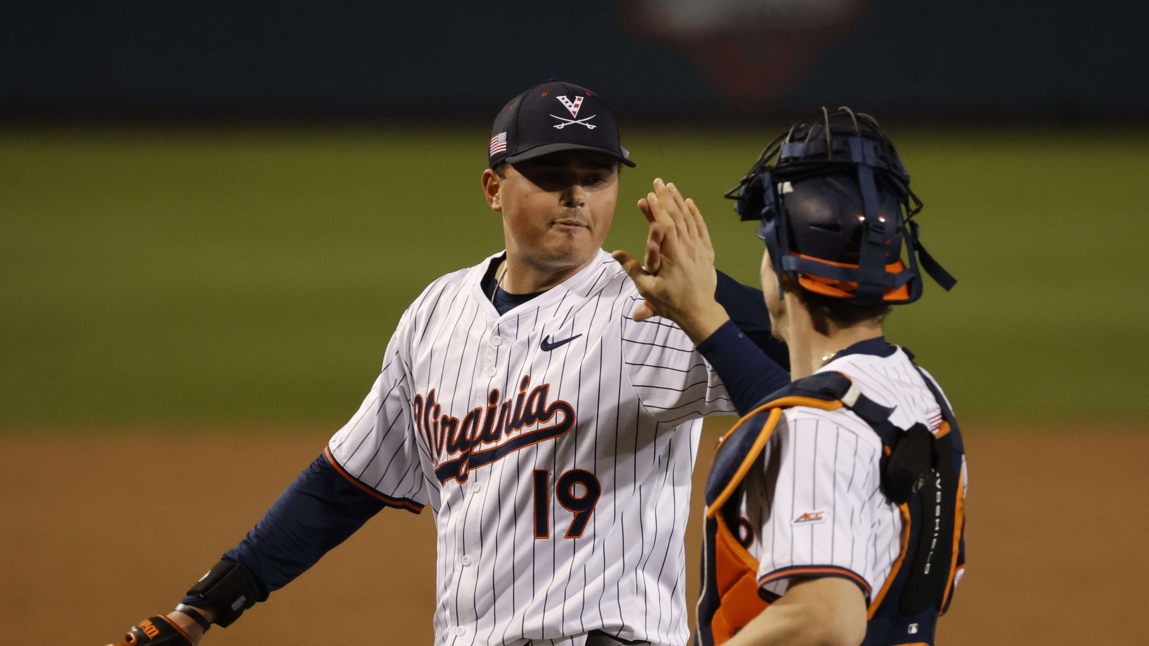 Owen Coady high fives Jacob Ference during the Virginia baseball game against Old Dominion at Disharoon Park.