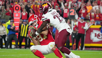 Oct 27, 2025; Kansas City, Missouri, USA; Kansas City Chiefs tight end Travis Kelce (87) makes a reception for a touchdown defended by Washington Commanders safety Darnell Savage (25) during the third quarter of the game at GEHA Field at Arrowhead Stadium. Mandatory Credit: Denny Medley-Imagn Images
