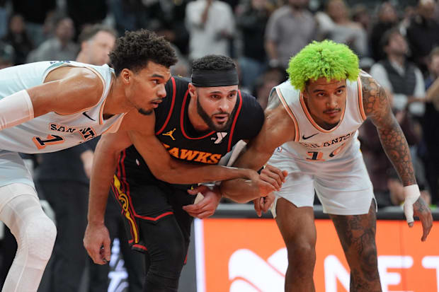 San Antonio Spurs center Victor Wembanyama (1) and forward Jeremy Sochan (10) surround Atlanta Hawks forward Larry Nance Jr. 