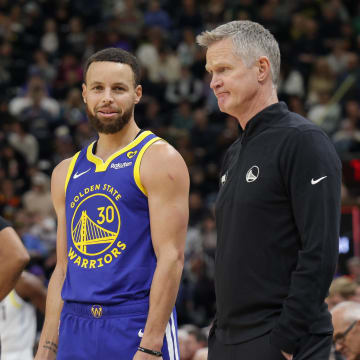 Feb 15, 2024; Salt Lake City, Utah, USA; Golden State Warriors guard Stephen Curry (30) and head coach Steve Kerr talk on the sideline during the first quarter against the Utah Jazz at Delta Center. Mandatory Credit: Chris Nicoll-USA TODAY Sports