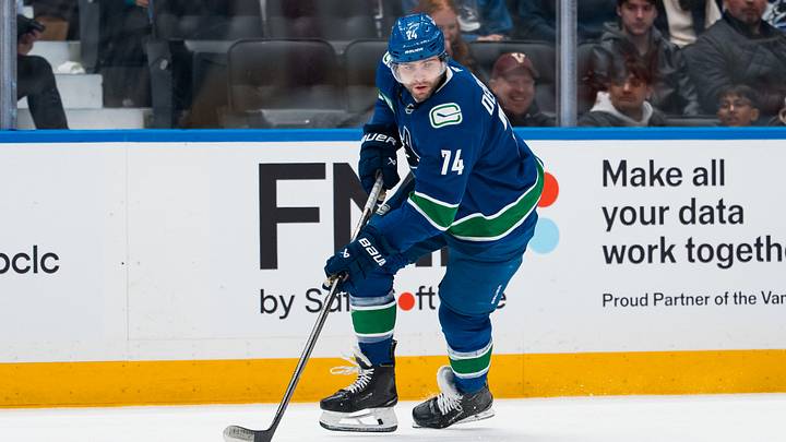 Apr 14, 2026; Vancouver, British Columbia, CAN; Vancouver Canucks forward Jake DeBrusk (74) handles the puck against the Los Angeles Kings in the second period at Rogers Arena. Mandatory Credit: Bob Frid-Imagn Images