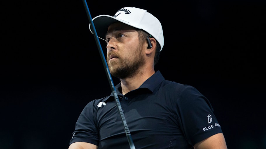Xander Schauffele of New York Golf Club tees off during a 2025 TGL semifinal match at SoFi Center.